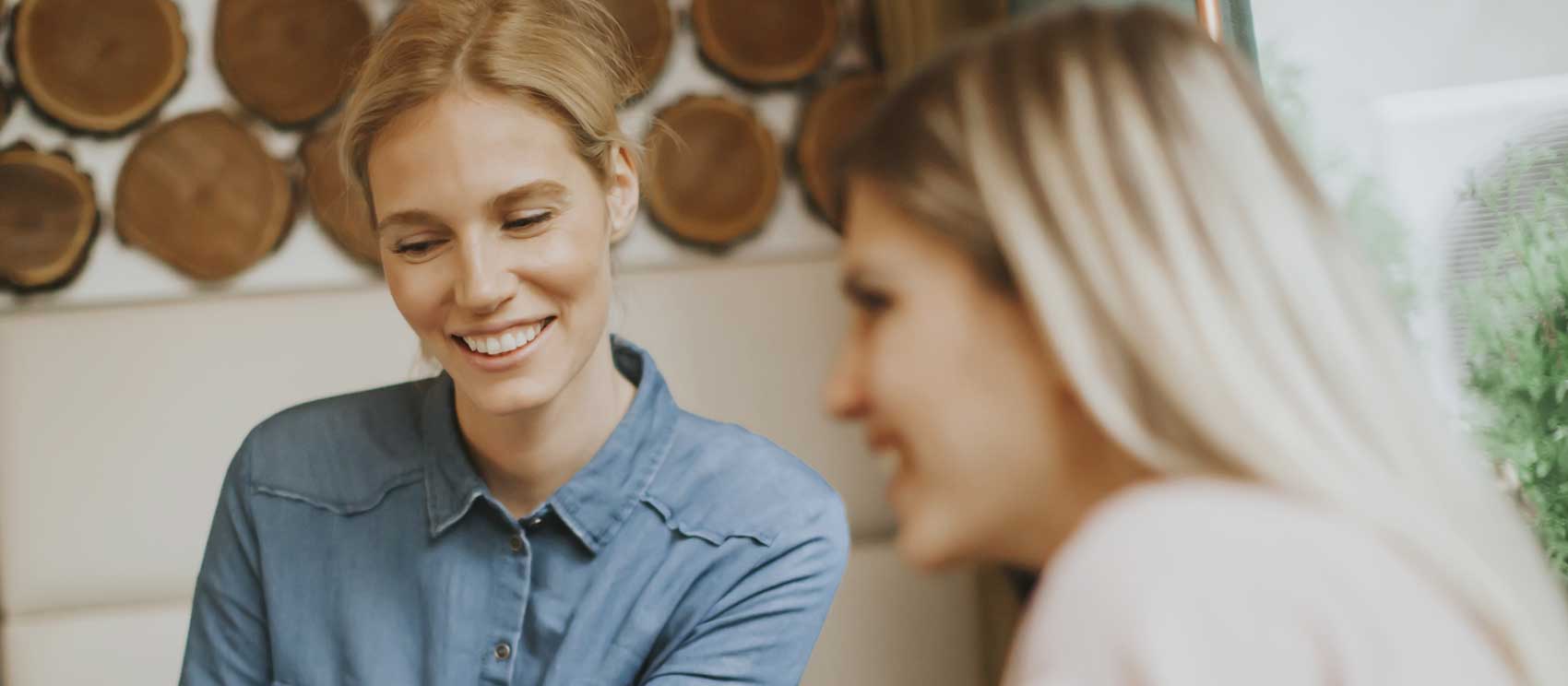 Two women discussing Mental Health Insurance Coverage and smiling